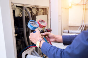 Technician is checking air conditioner ,measuring equipment for filling air conditioners